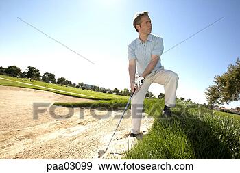 Stock Photograph - man hitting golf 
ball out of bunker. 
fotosearch - search 
stock photos, 
pictures, images, 
and photo clipart