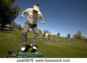 Stock Photo - man jumping on 
golf bag. fotosearch 
- search stock 
photos, pictures, 
images, and photo 
clipart