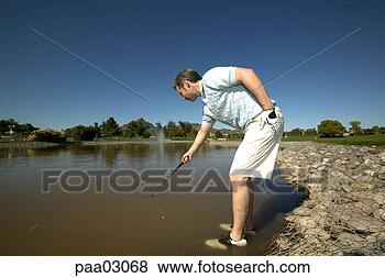 Stock Photo - man reaching into 
lake for golf 
ball. fotosearch 
- search stock 
photos, pictures, 
images, and photo 
clipart