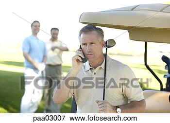 Picture - man talking on 
cell phone at 
golf course. fotosearch 
- search stock 
photos, pictures, 
images, and photo 
clipart