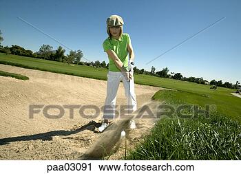 Stock Photography - woman hitting 
golf ball out 
of bunker. fotosearch 
- search stock 
photos, pictures, 
images, and photo 
clipart