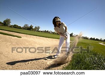Picture - woman hitting 
golf ball out 
of bunker. fotosearch 
- search stock 
photos, pictures, 
images, and photo 
clipart