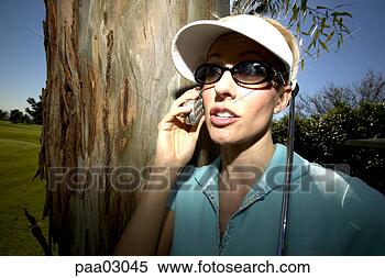 Stock Image - woman talking 
on cell phone 
on golf course. 
fotosearch - search 
stock photos, 
pictures, images, 
and photo clipart
