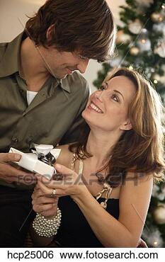 Stock Photo - couple exchanging 
christmas gifts. 
fotosearch - search 
stock photos, 
pictures, images, 
and photo clipart