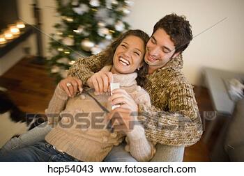 Stock Photo - couple hugging 
on couch. fotosearch 
- search stock 
photos, pictures, 
images, and photo 
clipart