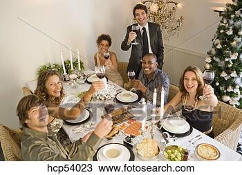 Stock Photo - friends toasting 
at dinner table. 
fotosearch - search 
stock photos, 
pictures, images, 
and photo clipart
