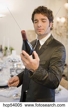 Stock Image - man examining 
bottle of wine. 
fotosearch - search 
stock photos, 
pictures, images, 
and photo clipart