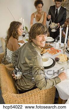 Stock Photo - man holding gift 
behind back at 
dinner table. 
fotosearch - search 
stock photos, 
pictures, images, 
and photo clipart