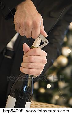 Stock Photo - man opening bottle 
of wine. fotosearch 
- search stock 
photos, pictures, 
images, and photo 
clipart