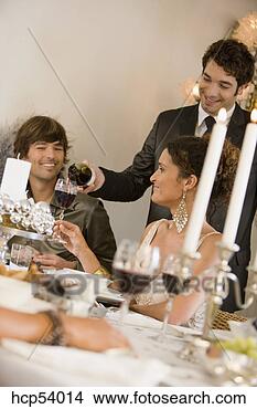 Stock Photo - man pouring wine 
at dinner party. 
fotosearch - search 
stock photos, 
pictures, images, 
and photo clipart