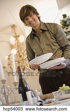 Stock Photo - man setting dinner 
table. fotosearch 
- search stock 
photos, pictures, 
images, and photo 
clipart