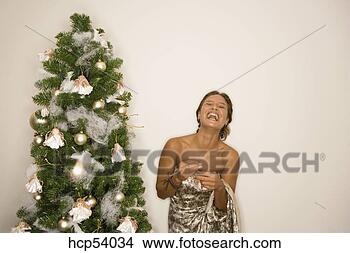 Stock Photo - woman decorating 
christmas tree. 
fotosearch - search 
stock photos, 
pictures, images, 
and photo clipart