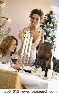 Stock Photo - woman lighting 
candles at dinner 
table. fotosearch 
- search stock 
photos, pictures, 
images, and photo 
clipart