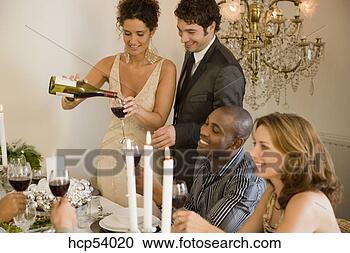 Stock Photography - woman pouring 
herself glass 
of wine at dinner 
table. fotosearch 
- search stock 
photos, pictures, 
images, and photo 
clipart