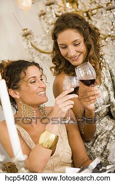 Stock Photo - women toasting 
each other with 
wine. fotosearch 
- search stock 
photos, pictures, 
images, and photo 
clipart