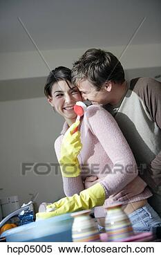 Stock Image - couple playing 
while washing 
dishes. fotosearch 
- search stock 
photos, pictures, 
images, and photo 
clipart
