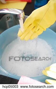 Stock Photo - person filling 
bucket with soapy 
water. fotosearch 
- search stock 
photos, pictures, 
images, and photo 
clipart