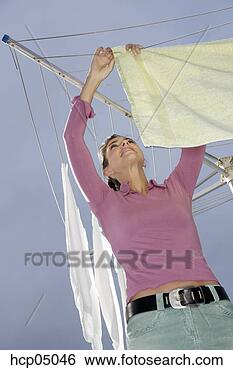 Stock Photo - woman hanging 
up laundry. fotosearch 
- search stock 
photos, pictures, 
images, and photo 
clipart