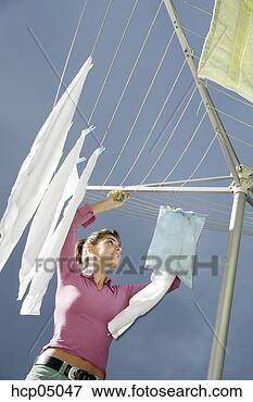 Picture - woman hanging 
up laundry. fotosearch 
- search stock 
photos, pictures, 
images, and photo 
clipart