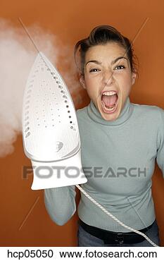 Stock Photography - woman holding 
steaming iron. 
fotosearch - search 
stock photos, 
pictures, images, 
and photo clipart