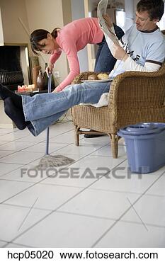 Stock Photography - woman mopping 
under husband's 
legs. fotosearch 
- search stock 
photos, pictures, 
images, and photo 
clipart