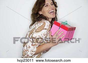 Stock Photography - laughing woman 
holding gift. 
fotosearch - search 
stock photos, 
pictures, images, 
and photo clipart
