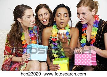 Stock Photograph - woman blowing 
out birthday candle 
with friends watching. 
fotosearch - search 
stock photos, 
pictures, images, 
and photo clipart