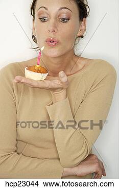 Stock Photo - woman blowing 
out birthday candle. 
fotosearch - search 
stock photos, 
pictures, images, 
and photo clipart