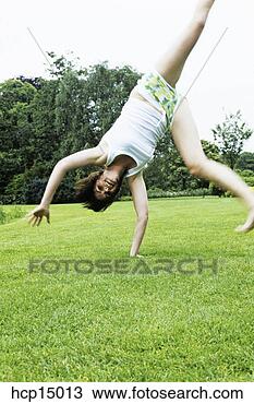 Stock Photo - woman doing cartwheel. 
fotosearch - search 
stock photos, 
pictures, images, 
and photo clipart
