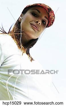 Stock Photograph - woman listening 
to headphones. 
fotosearch - search 
stock photos, 
pictures, images, 
and photo clipart