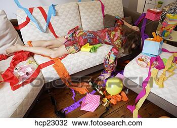 Stock Photo - woman sleeping 
on sofa after 
party. fotosearch 
- search stock 
photos, pictures, 
images, and photo 
clipart