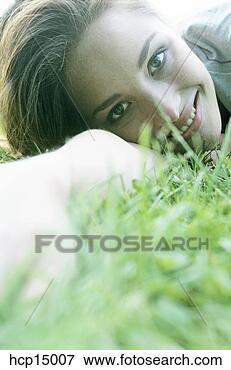 Picture - woman smiling 
in grass. fotosearch 
- search stock 
photos, pictures, 
images, and photo 
clipart