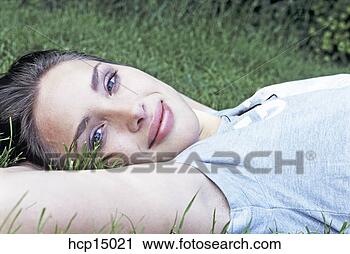 Stock Photography - woman smiling 
in grass. fotosearch 
- search stock 
photos, pictures, 
images, and photo 
clipart