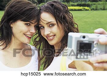 Stock Image - women taking self-portrait. 
fotosearch - search 
stock photos, 
pictures, images, 
and photo clipart