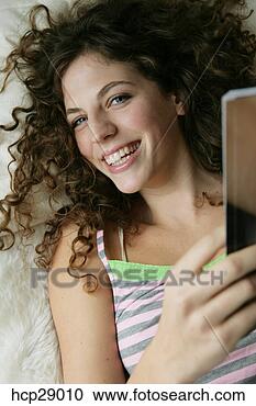 Stock Photography - young woman lying 
down. fotosearch 
- search stock 
photos, pictures, 
images, and photo 
clipart