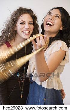 Stock Photo - young women laughing 
together. fotosearch 
- search stock 
photos, pictures, 
images, and photo 
clipart
