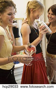 Stock Photo - young women mixing 
drinks with cocktail 
shaker. fotosearch 
- search stock 
photos, pictures, 
images, and photo 
clipart