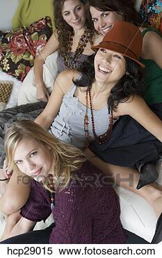 Stock Image - young women sitting 
together. fotosearch 
- search stock 
photos, pictures, 
images, and photo 
clipart