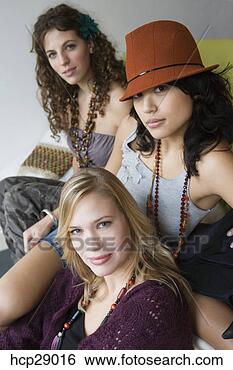 Stock Photo - young women sitting 
together. fotosearch 
- search stock 
photos, pictures, 
images, and photo 
clipart