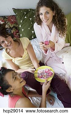 Stock Photo - young women wearing 
bathrobes with 
hair in rollers, 
eating cake. fotosearch 
- search stock 
photos, pictures, 
images, and photo 
clipart
