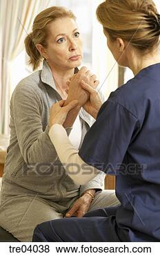 Stock Photo - female nurse examining 
woman's hand. 
fotosearch - search 
stock photos, 
pictures, images, 
and photo clipart
