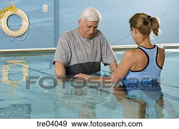 Stock Photograph - man having physical 
therapy in pool. 
fotosearch - search 
stock photos, 
pictures, images, 
and photo clipart