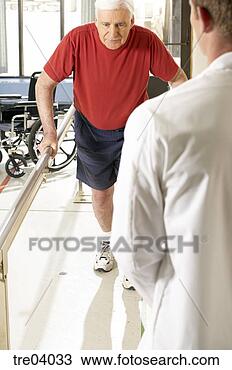 Stock Photo - man using bars 
to walk talking 
to physical therapist. 
fotosearch - search 
stock photos, 
pictures, images, 
and photo clipart