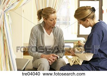 Stock Photography - nurse using skeleton 
to talk to patient. 
fotosearch - search 
stock photos, 
pictures, images, 
and photo clipart