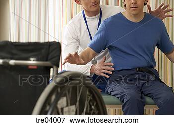 Picture - physical therapist 
helping wheelchair-bound 
man. fotosearch 
- search stock 
photos, pictures, 
images, and photo 
clipart