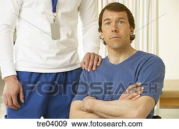 Stock Photograph - physical therapist 
standing by wheelchair-bound 
man. fotosearch 
- search stock 
photos, pictures, 
images, and photo 
clipart