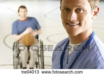 Stock Photo - physical therapist 
standing by wheelchair-bound 
man. fotosearch 
- search stock 
photos, pictures, 
images, and photo 
clipart