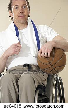 Stock Photo - wheelchair-bound 
man holding basketball. 
fotosearch - search 
stock photos, 
pictures, images, 
and photo clipart