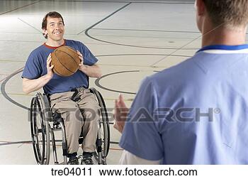 Stock Photography - wheelchair-bound 
man passing basketball 
to friend. fotosearch 
- search stock 
photos, pictures, 
images, and photo 
clipart