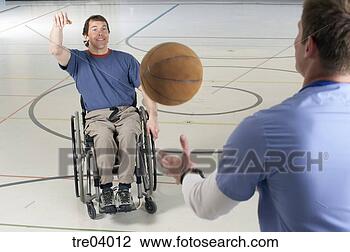 Stock Photo - wheelchair-bound 
man passing basketball 
to friend. fotosearch 
- search stock 
photos, pictures, 
images, and photo 
clipart
